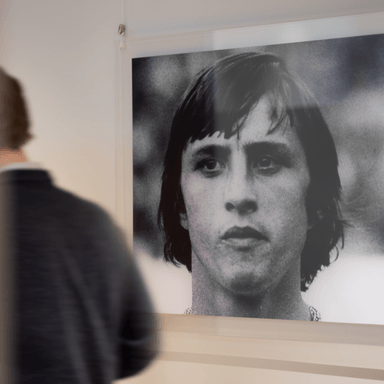 Man looking at black and white portrait in office HVK Stevens