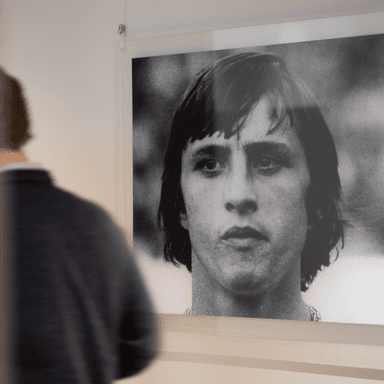Man looking at black and white portrait in office HVK Stevens