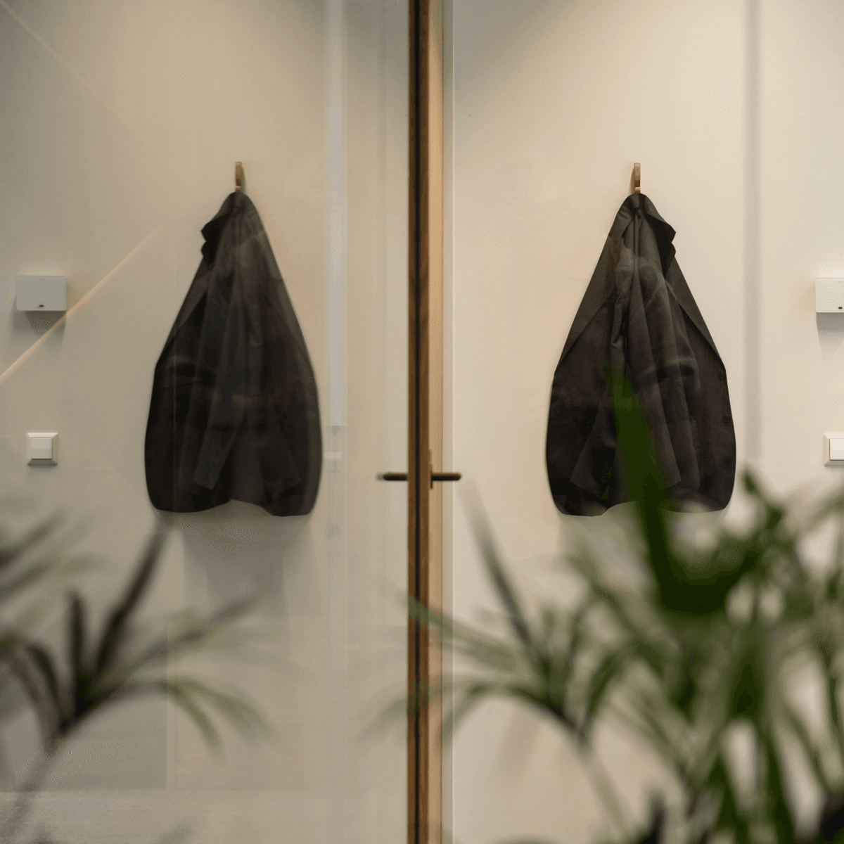 zwarte colbert aan kapstok in minimalistisch kantoorinterieur HVK Stevens