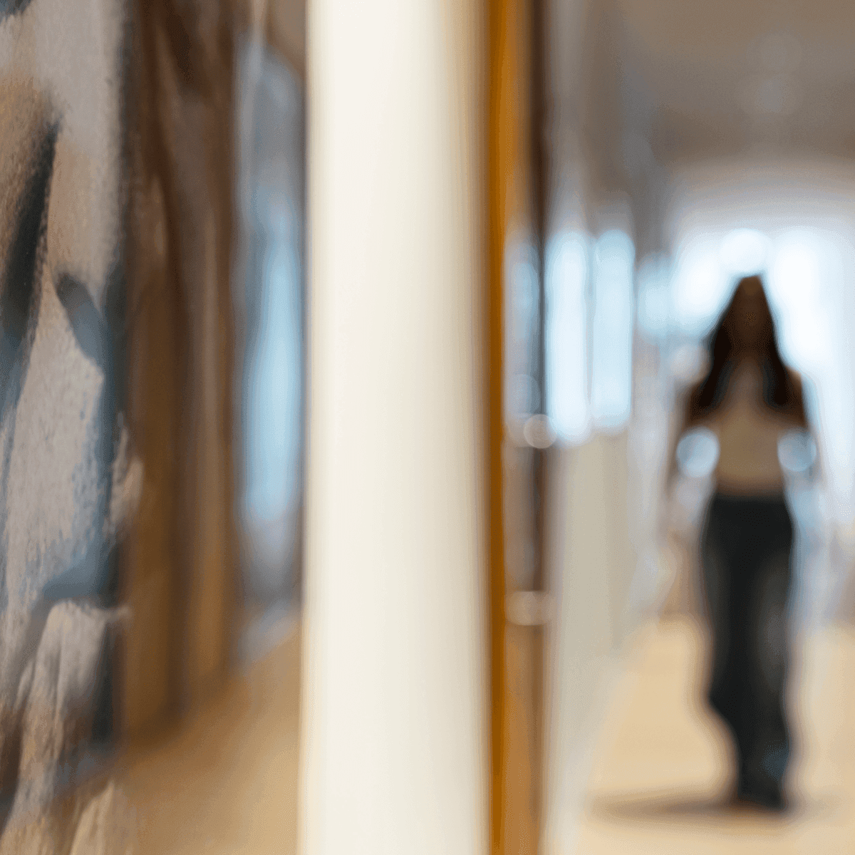 Blurred photo of woman walking through office hallway