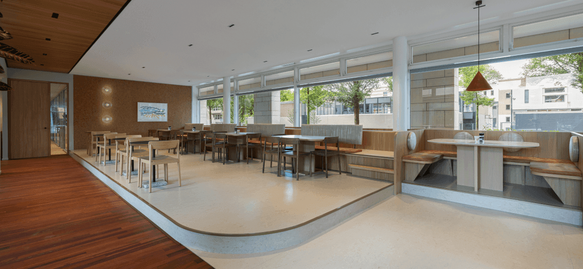 Company restaurant with wooden floor and multiple tables
