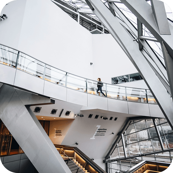 Modern architectural interior with glass walkway and steel beams in a contemporary building